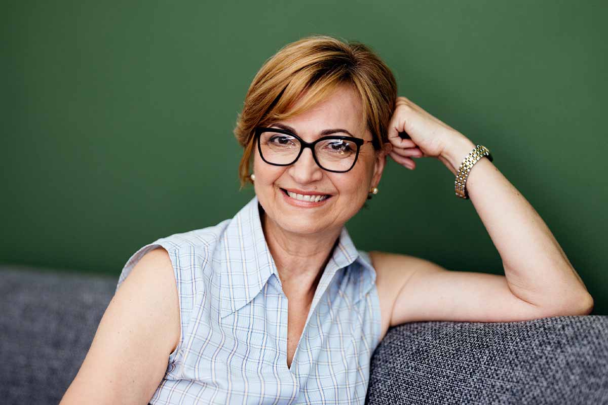 Woman sitting on couch after PRP hair restoration in Miami