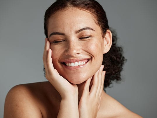 woman happy after getting hairline lowering surgery in Miami, FL