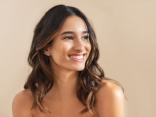 happy woman in Miami, FL, after getting hairline lowering surgery